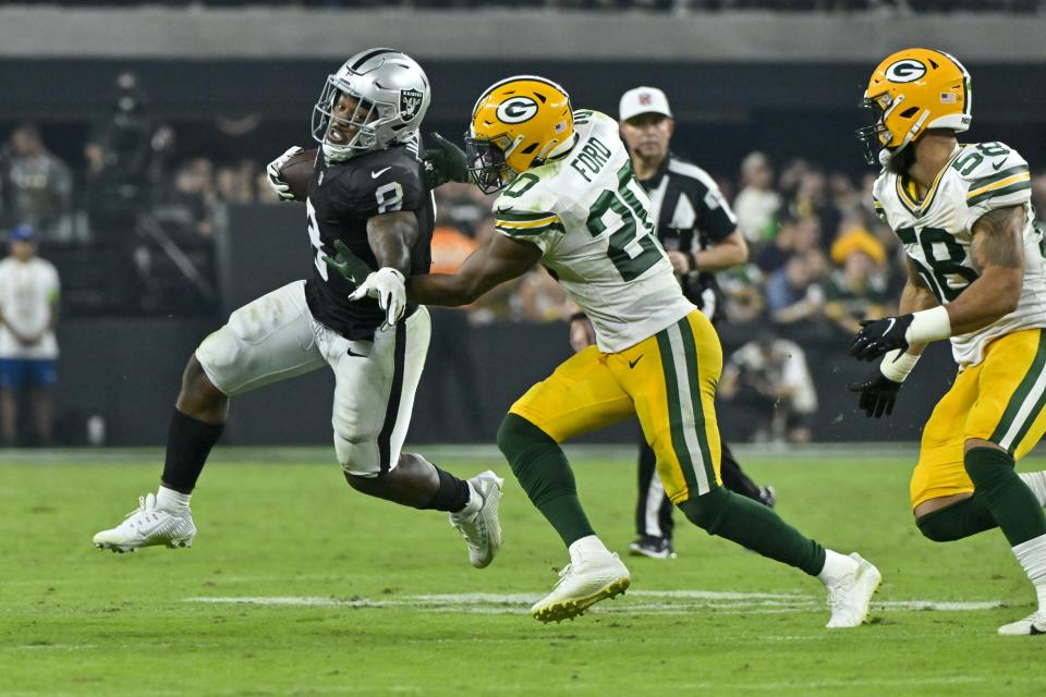 Las Vegas Raiders' Josh Jacobs tries to run past Green Bay Packers' Rudy Ford during the second half of an NFL football game Monday, Oct. 9, 2023, in Las Vegas. (AP Photo/David Becker)