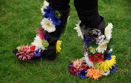 A woman displays her floral decorated boots at the RHS Chelsea Flower Show in London, Britain, May 21, 2018. REUTERS/Toby Melville