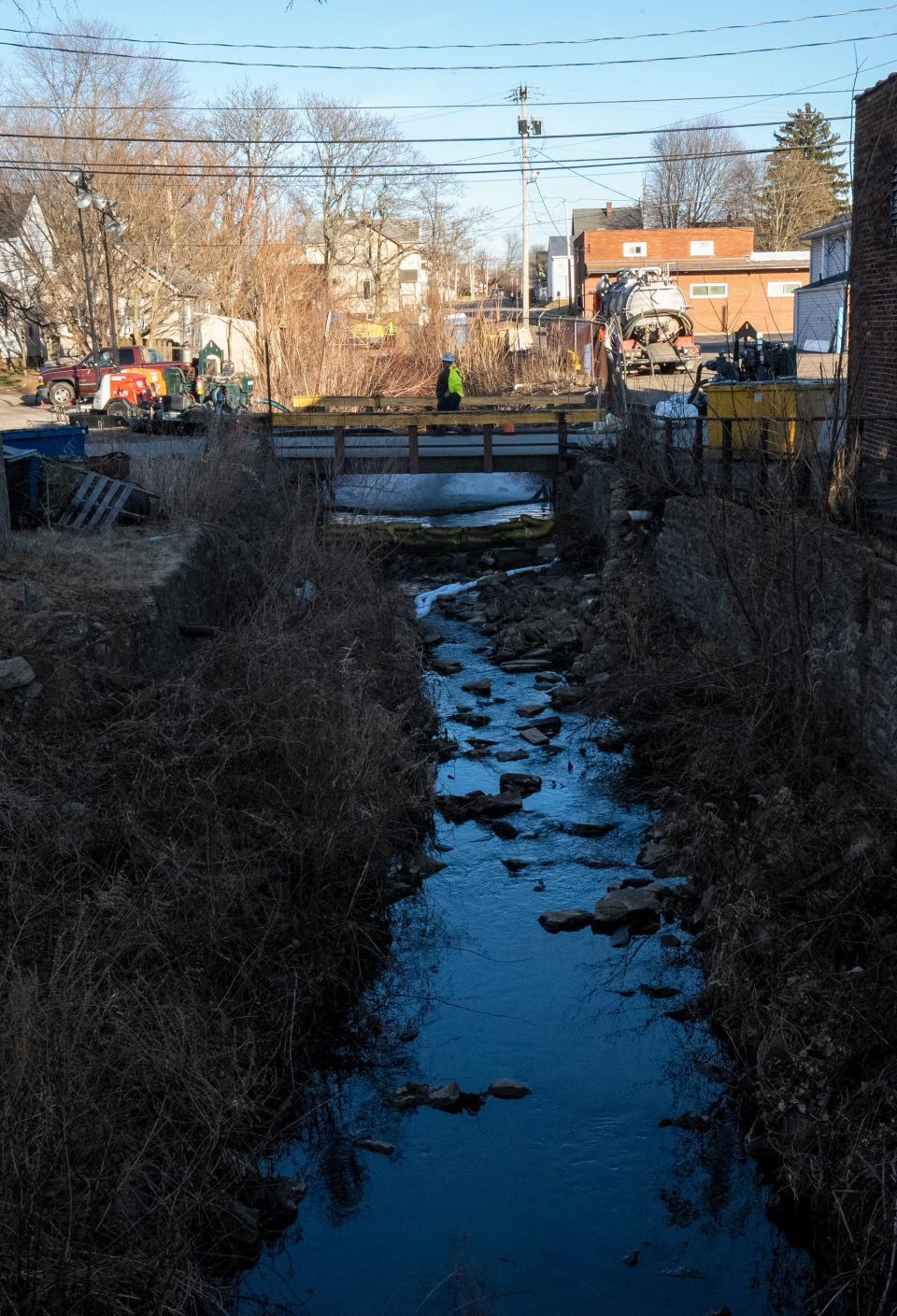Feb 21, 2023; East Palestine, Ohio, USA; Workers pump water into a creek that runs through East Palestine. Mandatory Credit: Brooke LaValley/Columbus Dispatch