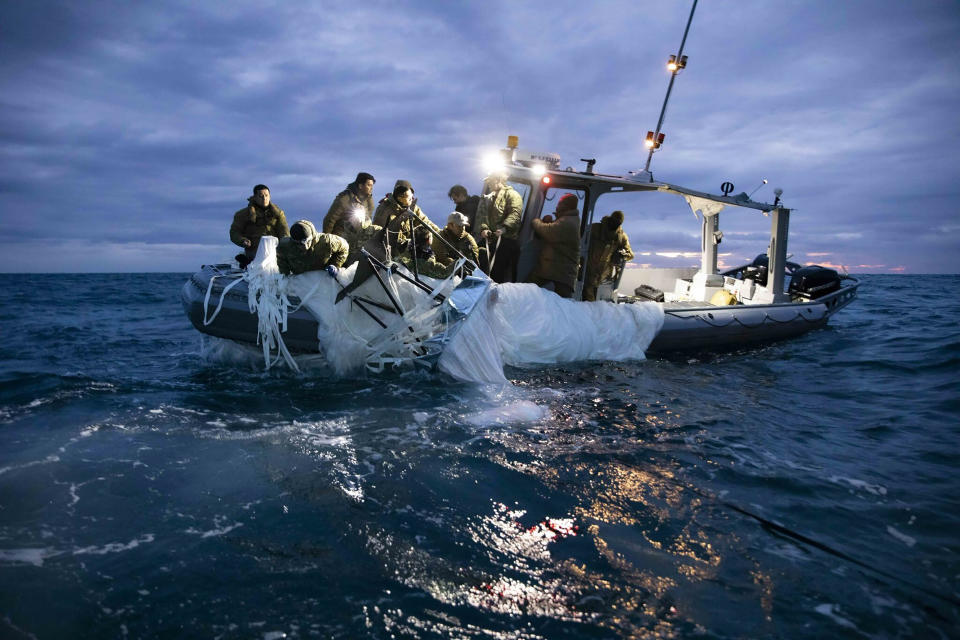 FILE - This image provided by the U.S. Navy shows sailors assigned to Explosive Ordnance Disposal Group 2 recovering a high-altitude surveillance balloon off the coast of Myrtle Beach, S.C., Feb. 5, 2023. Members of Congress are grappling with what to do after the downing of a Chinese balloon and three other aerial objects over American airspace. The episode has raised troubling questions about the security of American airspace. (U.S. Navy via AP, File)