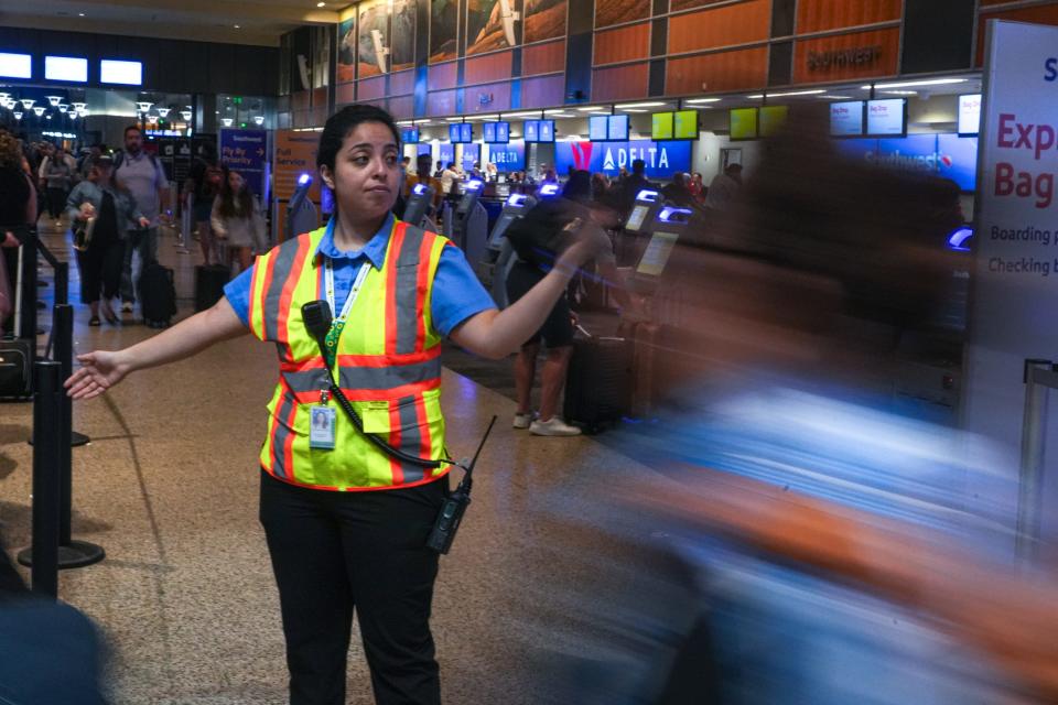 Guest Services worker Natalie Salazar directs foot traffic inside Austin-Bergstrom International Airport on Thursday, June 29, 2023 in Austin.