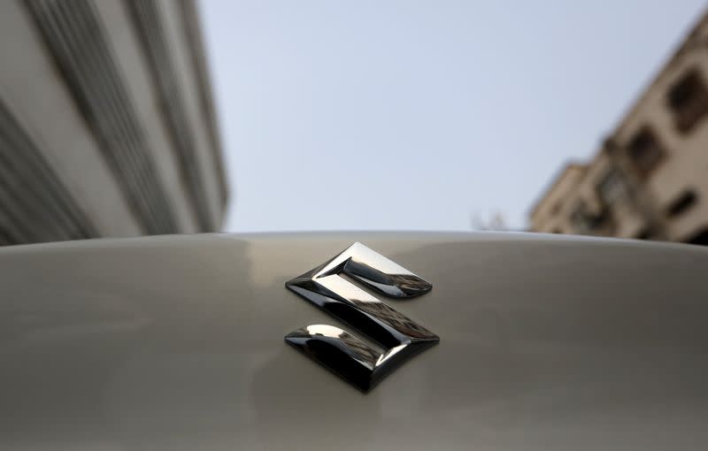 The logo of Maruti Suzuki India Limited is pictured on a car parked outside a showroom in New Delhi