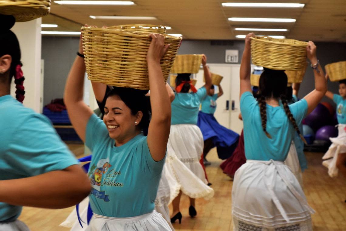 Nidya Juárez, 39, laughed as she twirled during a dance number with the Grupo Folklórico Tangu Yuu group on Sept. 20, 2022 in Fresno. The group was preparing their traditionally Oaxacan routine for the Guelaguetza festivities on Sunday.