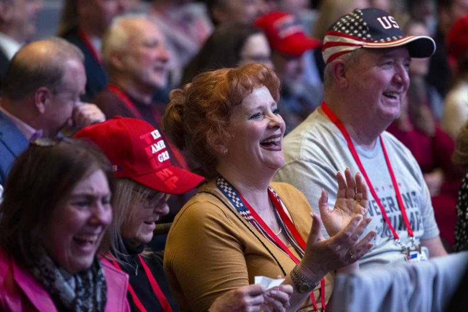 Supporters of Donald Trump applauds as he speaks.