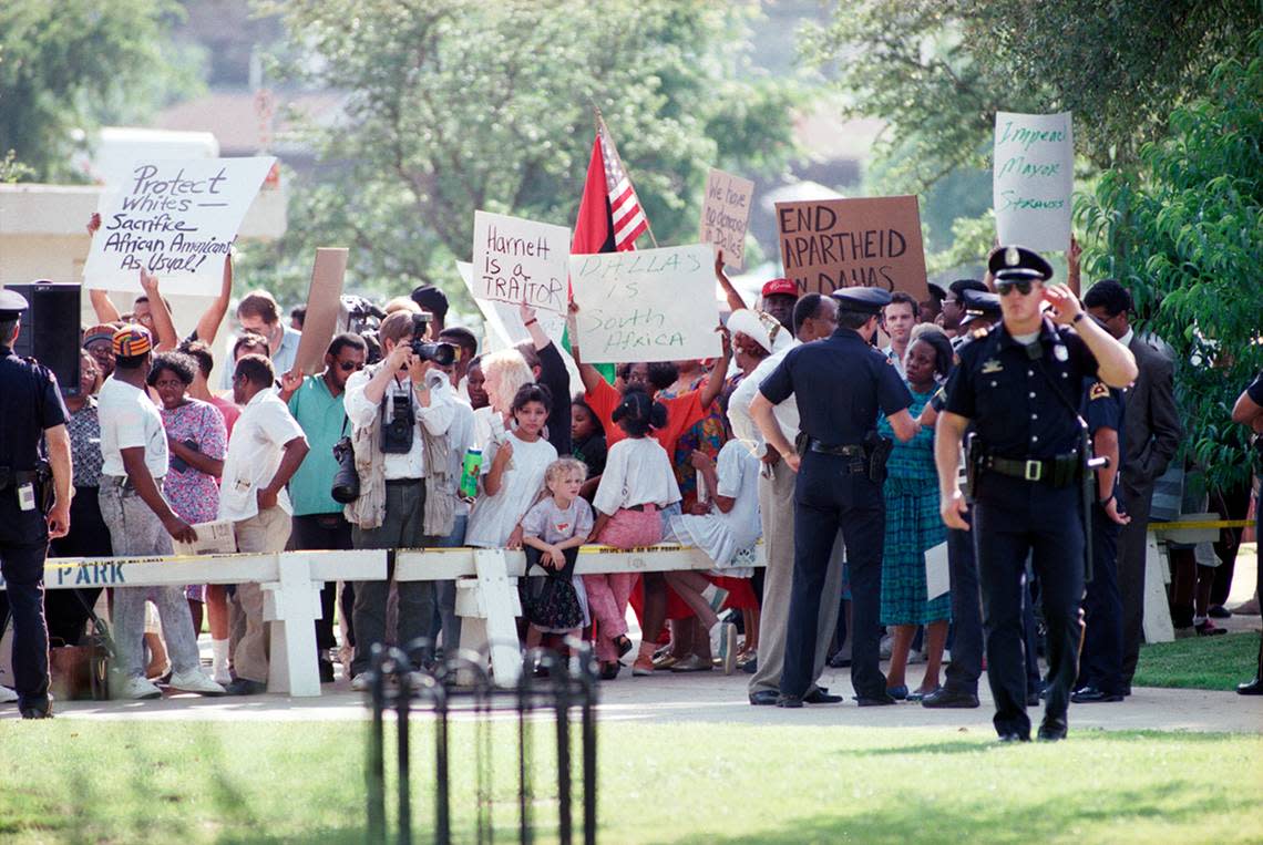 Dallas Mayor Pro Tem Diane Ragsdale, surrounded by Dallas police, protests Queen Elizabeth II’s visit to Dallas.