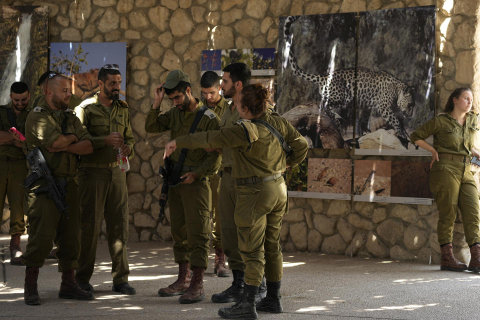 Israeli soldiers gather at the entrance to the site of a rockslide that took place in the Ein Gedi Nature Reserve, on the western shore of the Dead Sea, a popular tourist site in Israel, Thursday, Aug. 24, 2023. An avalanche of rock tumbled down a hillside near the Dead Sea, Israeli medics said, injuring several people. (AP Photo/Ohad Zwigenberg)