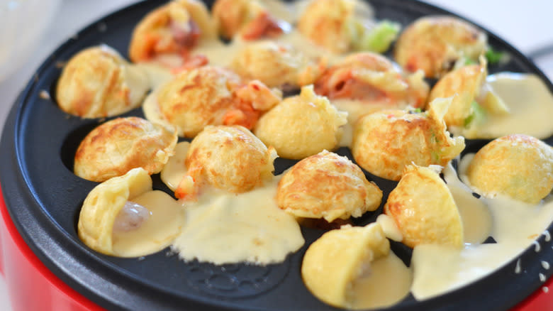 Cooking takoyaki in a takoyaki maker