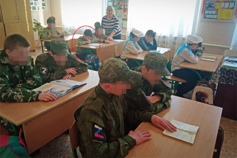 In a photo posted on Perevalsk Special Correctional Boarding School's website, Nikita can be seen reading at his desk during a lesson. (Perevalsk Special Correctional Boarding School)