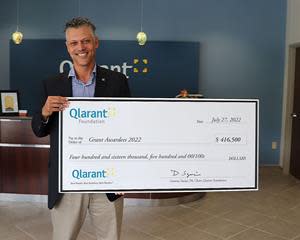 CEO Dr. Ron Forsythe, Jr presents the Qlarant Foundation Annual Grantee check to many charities throughout MD and D.C.