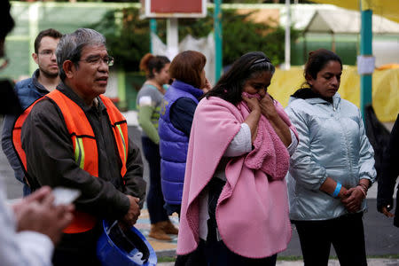 People who are living in a shelter because their homes were damaged in an earthquake, react after a tremor was felt in Mexico City, Mexico September 23, 2017. REUTERS/Daniel Becerril