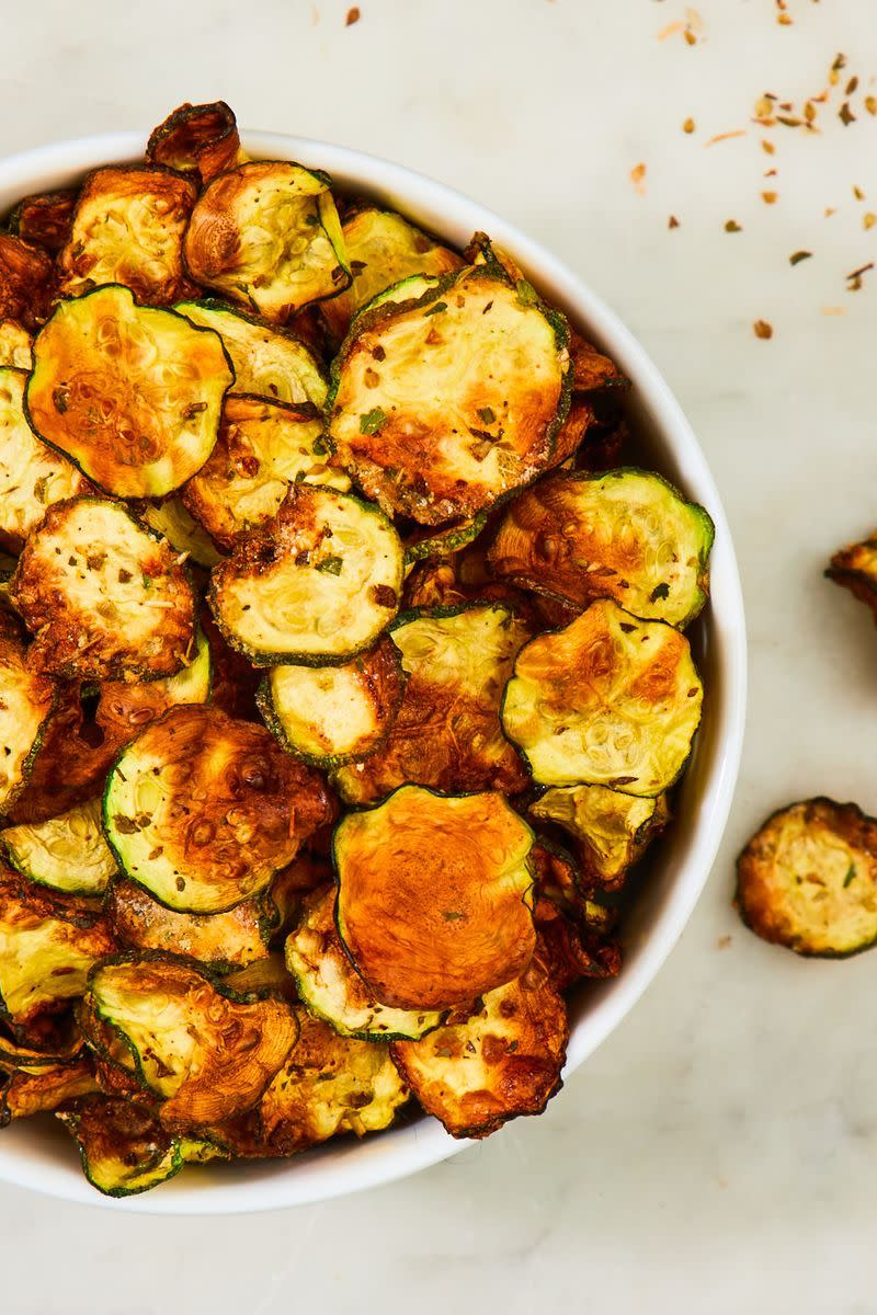 <p>How thinly you slice your courgette will affect how long it'll take in the oven. We recommend checking on the crisps after about an hour, though it'll almost definitely take longer than that. </p><p>Get the <a href="https://www.delish.com/uk/cooking/recipes/a28977233/cool-ranch-zucchini-chips/" rel="nofollow noopener" target="_blank" data-ylk="slk:Courgette Crisps;elm:context_link;itc:0;sec:content-canvas" class="link ">Courgette Crisps</a> recipe.</p>