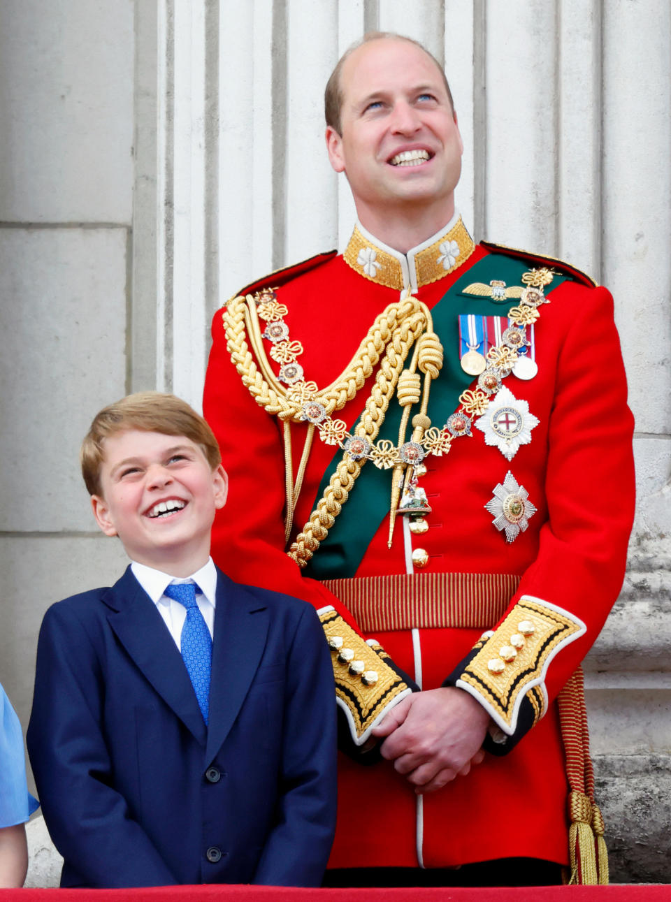 Prince George and Prince William watching a flypast from the balcony of Buckingham Palace during Trooping the Colour