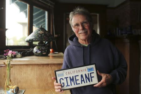 Country Joe McDonald, a musician who was the lead singer in the 1960's band "Country Joe and the Fish," poses with his vanity license plate at his home in Berkeley, December 9, 2014. REUTERS/Robert Galbraith