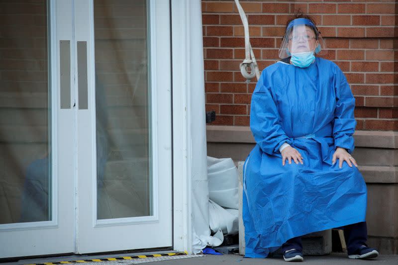 A healthcare worker takes a break outside the emergency center at Maimonides Medical Center during the outbreak of the coronavirus disease (COVID-19) in Brooklyn