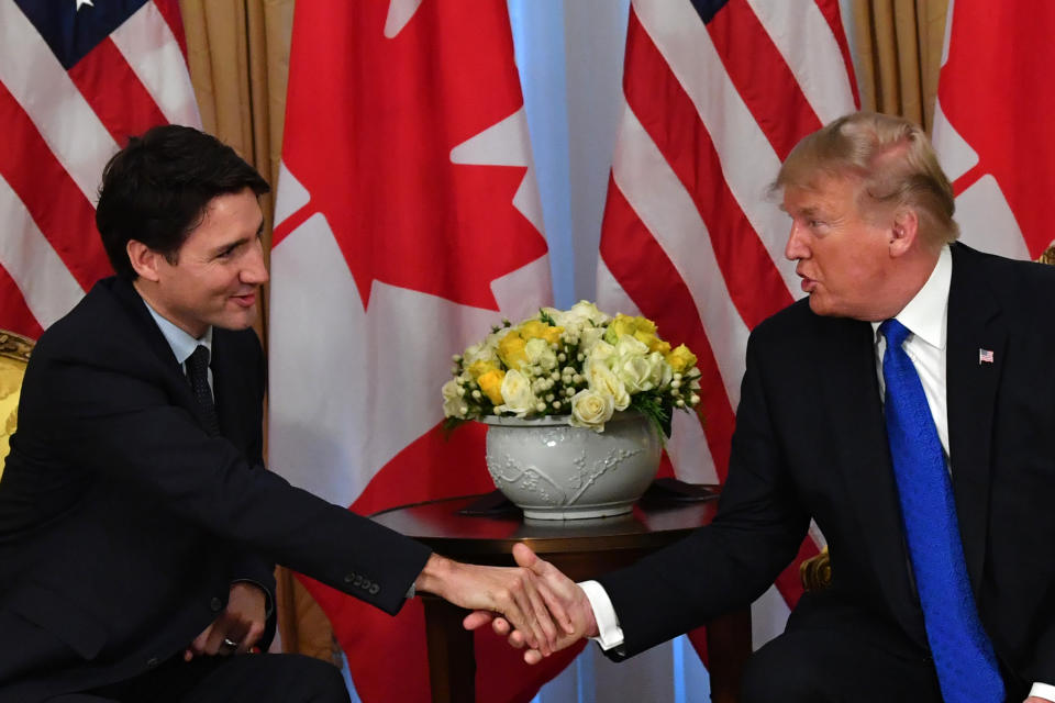 President Trump shakes hands with Canadian Prime Minister Justin Trudeau during a meeting in London on Tuesday. (Photo by Nicholas Kamm/AFP via Getty Images)