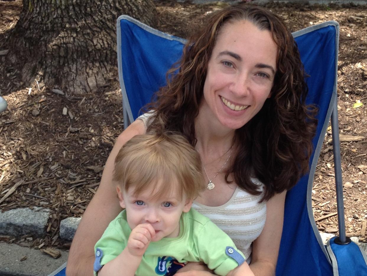 Lindsey Roger-Seitz sits on a camp chair with her baby son, Ben.