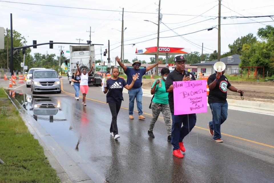 Rev. Dwight Futch (Left) and Alan Mainor leading community members on their march for Saudi Aria Lee to city hall on Saturday, July 16, 2022