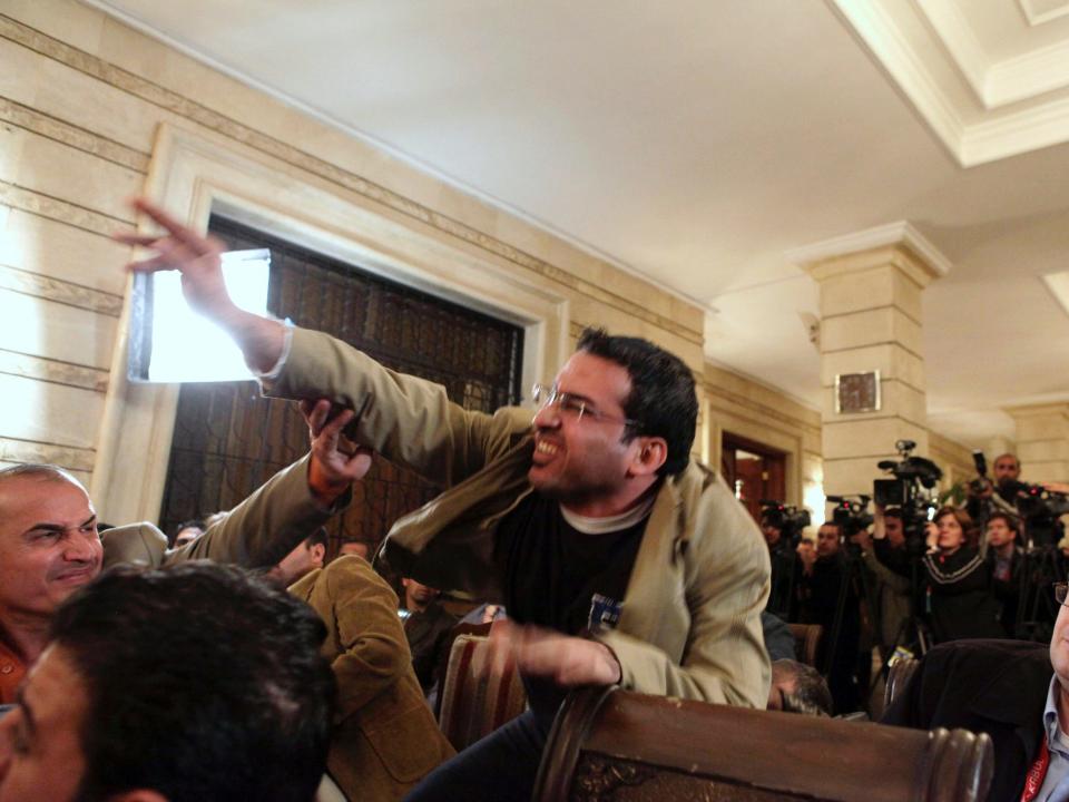 An Iraqi man throws a shoe at President George W. Bush during a new conference with Iraq Prime Minister Nouri al-Maliki on Sunday, Dec. 14, 2008, in Baghdad.