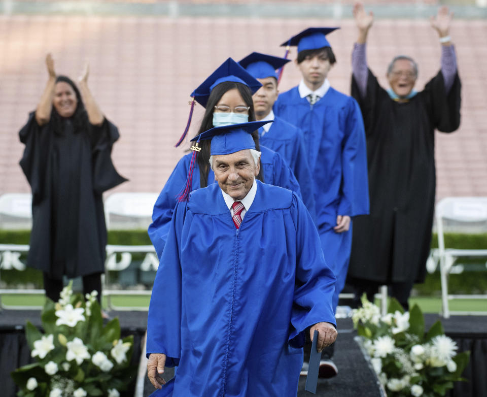 Ted Sams, 78, receives his original high school diploma during San Gabriel High School's graduation at the Rose Bowl on Friday, May 27, 2022, in Pasadena, Calif. (Sarah Reingewirtz/The Orange County Register via AP)