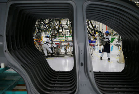 Workers are seen assembling a Mitsubishi Pajero at the Mitsubishi car factory in Bekasi, West Java province, Indonesia April 25, 2017. REUTERS/Beawiharta