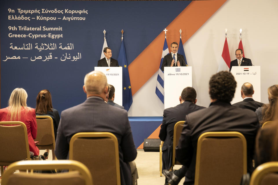 Greece's Prime Minister Kyriakos MItsotakis, center, Cyprus' President Nicos Anastasiades, left, and Egypt's President Abdel Fattah al-Sisi make statements following a meeting in Athens, Greece, Tuesday, Oct. 19, 2021. Athens hosts the 9th trilateral meeting between the three countries. (AP Photo/Yorgos Karahalis)