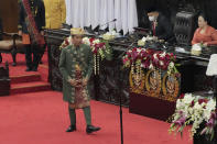 Indonesian President Joko Widodo, wearing traditional Bangka Belitung outfit, walks to the podium to deliver his annual State of the Nation Address ahead of the country's Independence Day, at the parliament building in Jakarta, Indonesia, Tuesday, Aug. 16, 2022. (AP Photo/Tatan Syuflana, Pool)