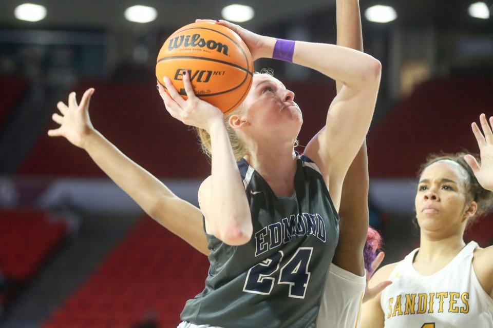 Edmond North's Laci Steele goes up for a basket while Sand Springs' Layne Kirkendoll defends during a 55-35 win Friday in the Class 6A semifinals at Lloyd Noble Center in Norman.