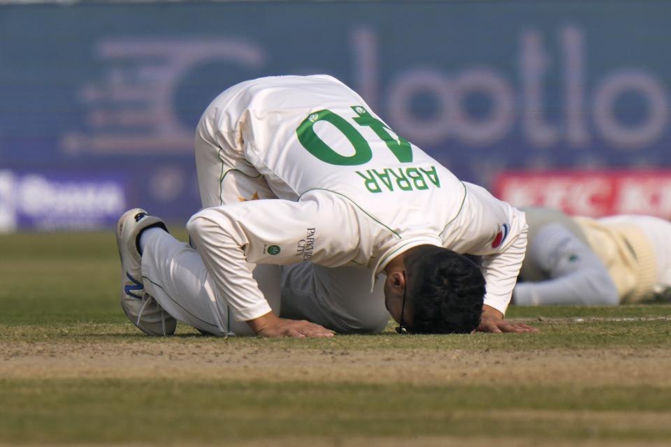Pakistan's Abrar Ahmed kisses the group after taking his fifth wicket of England's Harry Brook during the first day of the second test cricket match between Pakistan and England, in Multan, Pakistan, Friday, Dec. 9, 2022. (AP Photo/Anjum Naveed)