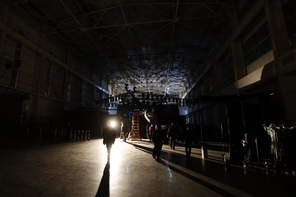 The interior of the Brooklyn Navy Yard's Duggal Greenhouse is darkened during a rehearsal before the Alexander Wang Fall 2014 collection show during Fashion Week in New York, Saturday, Feb. 8, 2014. (AP Photo/Jason DeCrow)