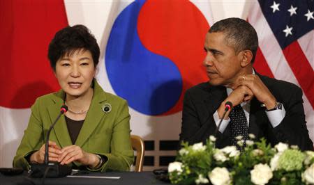 U.S. President Barack Obama listens to South Korean President Park Geun-hye speak during a tri-lateral meeting with Japanese Prime Minister Shinzo Abe after the Nuclear Security Summit in The Hague March 25, 2014. REUTERS/Kevin Lamarque