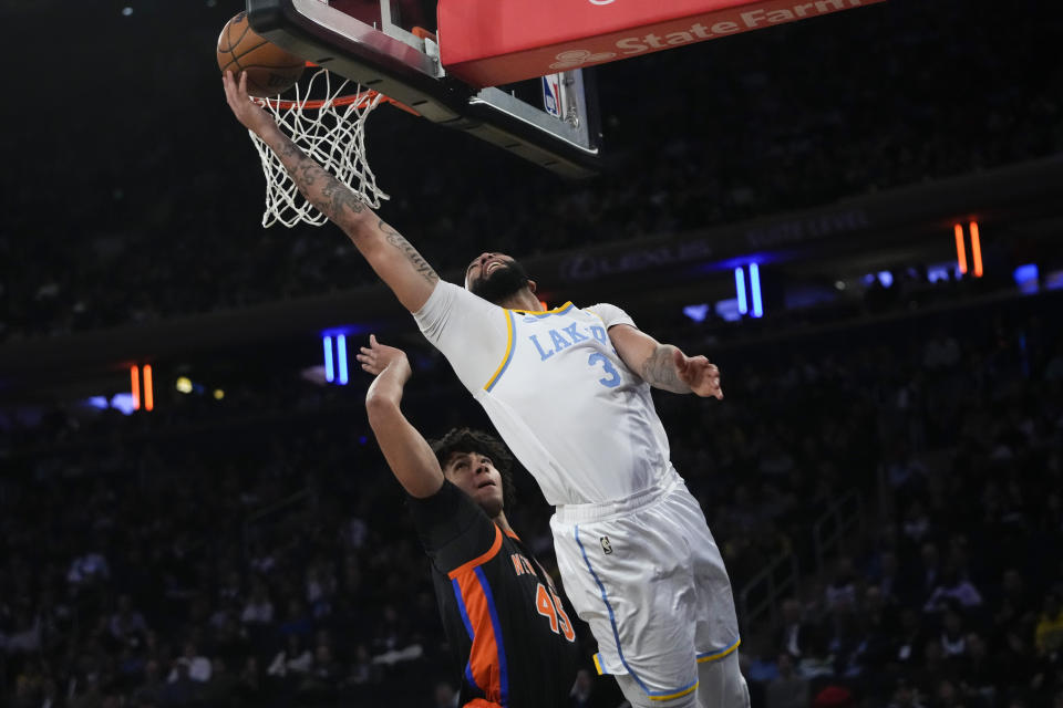 Los Angeles Lakers' Anthony Davis (3) drives past New York Knicks' Jericho Sims (45) during the second half of an NBA basketball game Tuesday, Jan. 31, 2023, in New York. (AP Photo/Frank Franklin II)