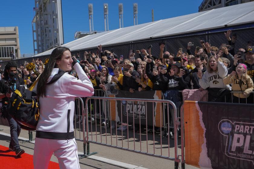 Fans cheer as Iowa's Caitlin Clark arrives for the NCAA Women's championship basketball game against South Carolina