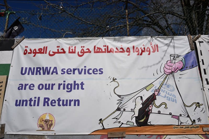 A banner hangs on a fence for services from the United Nations Relief and Works Agency for Palestine Refugees in the the Near East in the Aida Refugee Camp near Bethlehem, West Bank, on Tuesday. Photo by Debbie Hill/ UPI