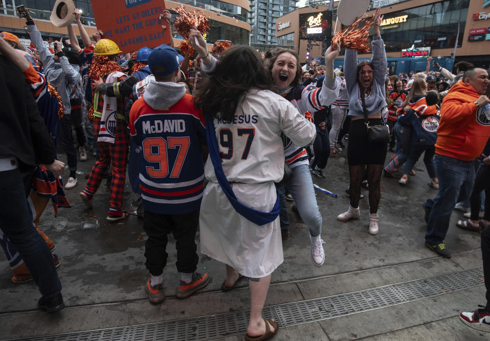 Edmonton Oilers fans celebrate the team's win over the Florida Panthers, as fans watched coverage of Game 5 of the NHL hockey Stanley Cup Final, Tuesday, June 18, 2024, in Edmonton, Alberta. (Jason Franson/The Canadian Press via AP)