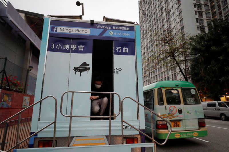 Curriculum officer Evan Kam prepares before a piano class on Ming’s Piano truck, following the novel coronavirus disease (COVID-19) outbreak, in Hong Kong