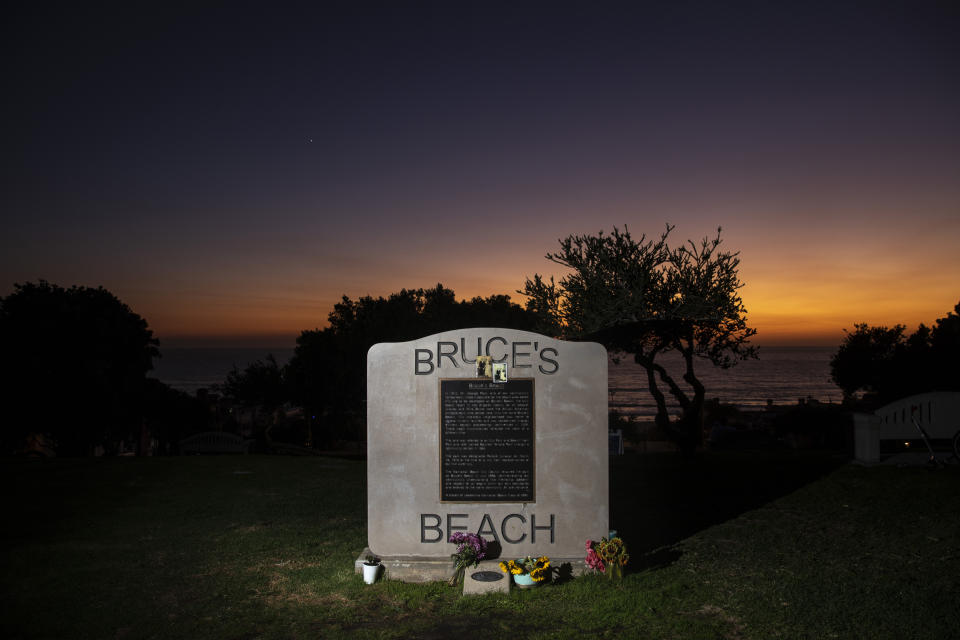 Image: The sun sets behind a plaque memorializing a park adjacent to Bruce's Beach, in Manhattan Beach, Calif., on Sept. 30, 2021. (Jay L. Clendenin / Los Angeles Times via Getty Images file)