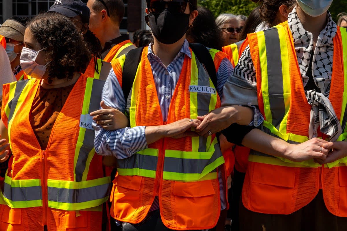 Faculty of Columbia University link arms to protect students inside threatened with suspension if they refused to voluntarily dismantle the pro-Palestine encampment on campus by 2 pm on April 29, 2024 in New York City.  (Getty Images)