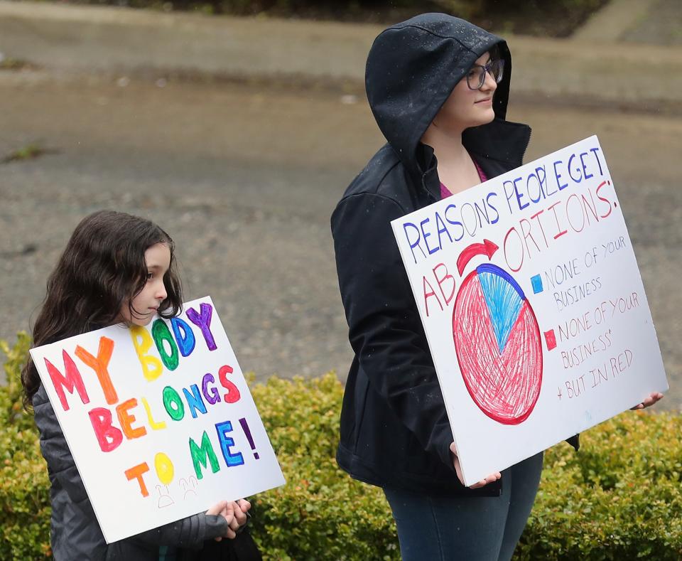 Sisters Audrey Lugo, left, and Evelyn Ulrich take part in a rally for reproductive rights at the Norm Dicks Government Center in Bremerton on Friday.