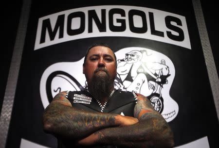 A member of the Mongols Motorcycle Club, known only as 'Paul', poses for a photograph in their clubhouse located in western Sydney November 9, 2014. REUTERS/David Gray