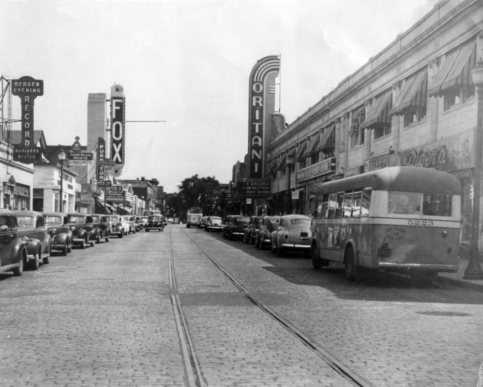 The Fox and Oritani movie theaters vying face to face on opposite sides of Main Street before being repaved in Hackensack, N.J. in 1942.