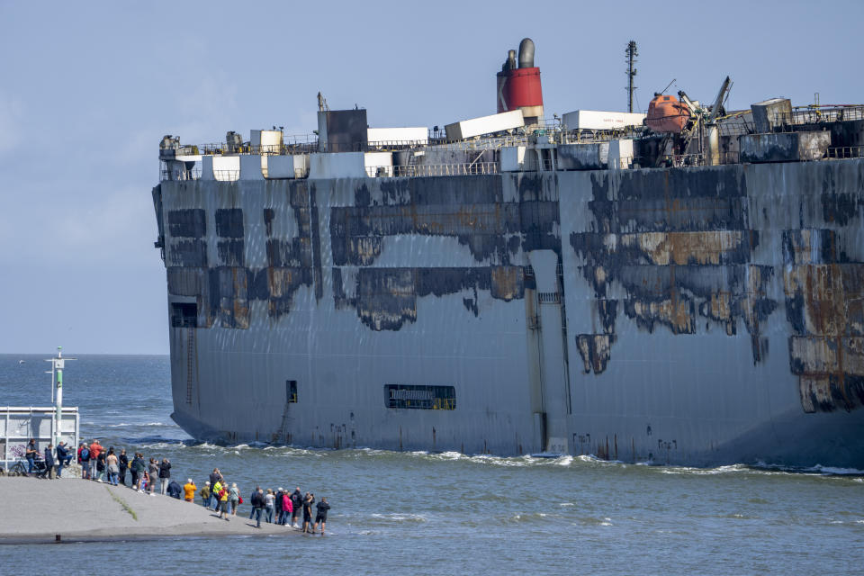 Stricken cargo ship Fremantle Highway, that caught fire while transporting thousands of cars, including nearly 500 electric vehicles, from Germany to Singapore, is towed into the port of Eemshaven, the Netherlands, on Thursday, Aug. 3, 2023. The ship that burned for almost a week close to busy North Sea shipping lanes and a world renowned migratory bird habitat will be salvaged at the northern Dutch port. (AP Photo/Peter Dejong)