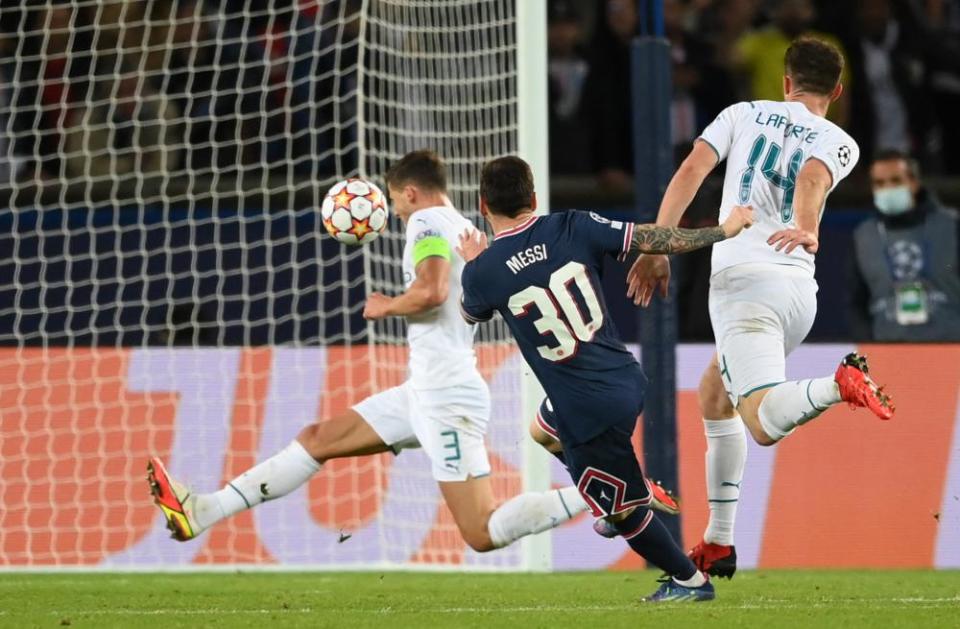 Lionel Messi guides his shot into the roof of the net.