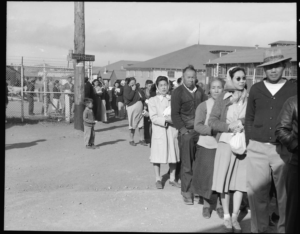 Japanese Americans waiting in line for dinner at internment camps