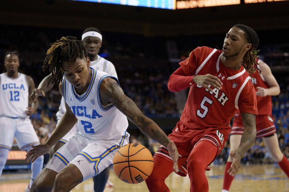 UCLA guard Dylan Andrews (2) and Utah guard Deivon Smith (5) go for a loose ball during the first half of an NCAA college basketball game, Sunday, Feb. 18, 2024, in Los Angeles. | Eric Thayer, AP
