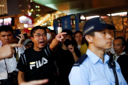 People react over the presence of police during rally held by the Hong Kong Confederation of Trade Unions after a number of crew members in the aviation industry were let go for joining the anti-extradition bill protests, in Hong Kong