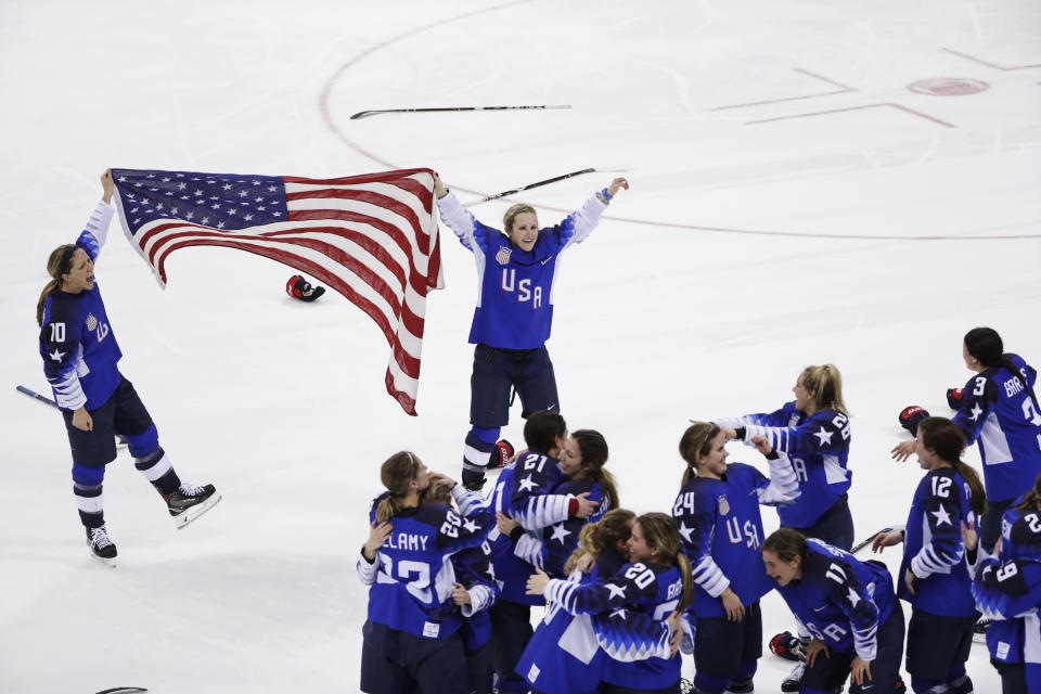 FILE - In this Feb. 22, 2018, file photo, Meghan Duggan (10), of the United States, and Monique Lamoureux-Morando (7), also of the United States, celebrate with teammates after defeating Canada in the women's gold medal hockey game at the Winter Olympics in Gangneung, South Korea. U.S. women's hockey captain Duggan announced her retirement Tuesday, Oct. 13, 2020, after a career in which she won the 2018 Olympic gold medal and seven world championship golds. (AP Photo/Matt Slocum, File)