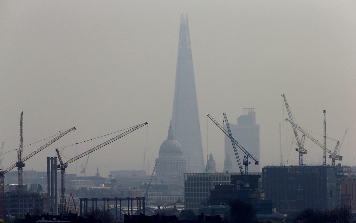Smog blankets the Shard and St Paul's Cathedral in London - REUTERS