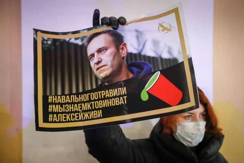 FILE PHOTO: An activist holds a portrait of opposition politician Alexei Navalny during a picket in his support in Saint Petersburg