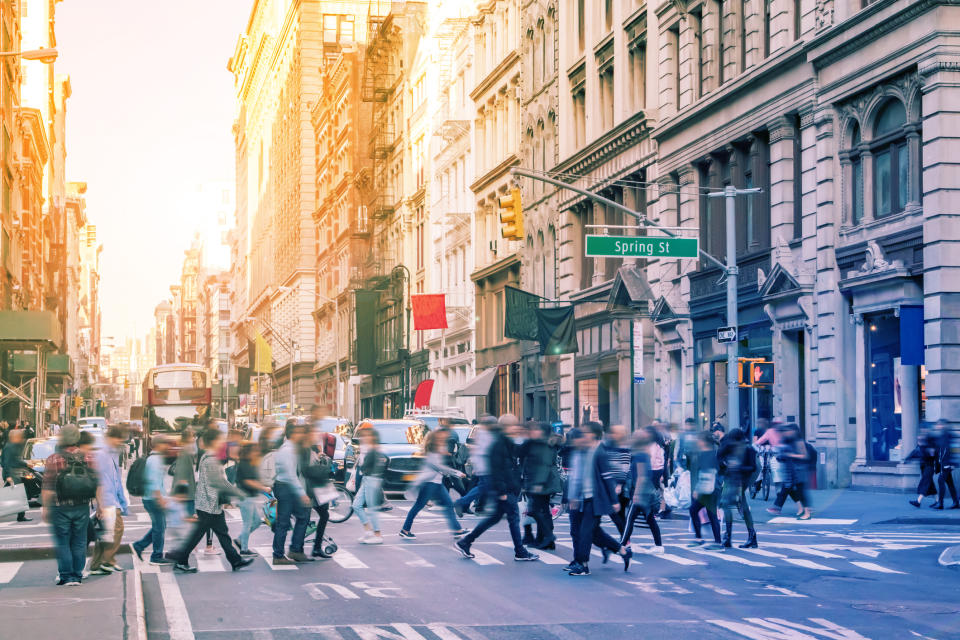 People walking across a street in NYC