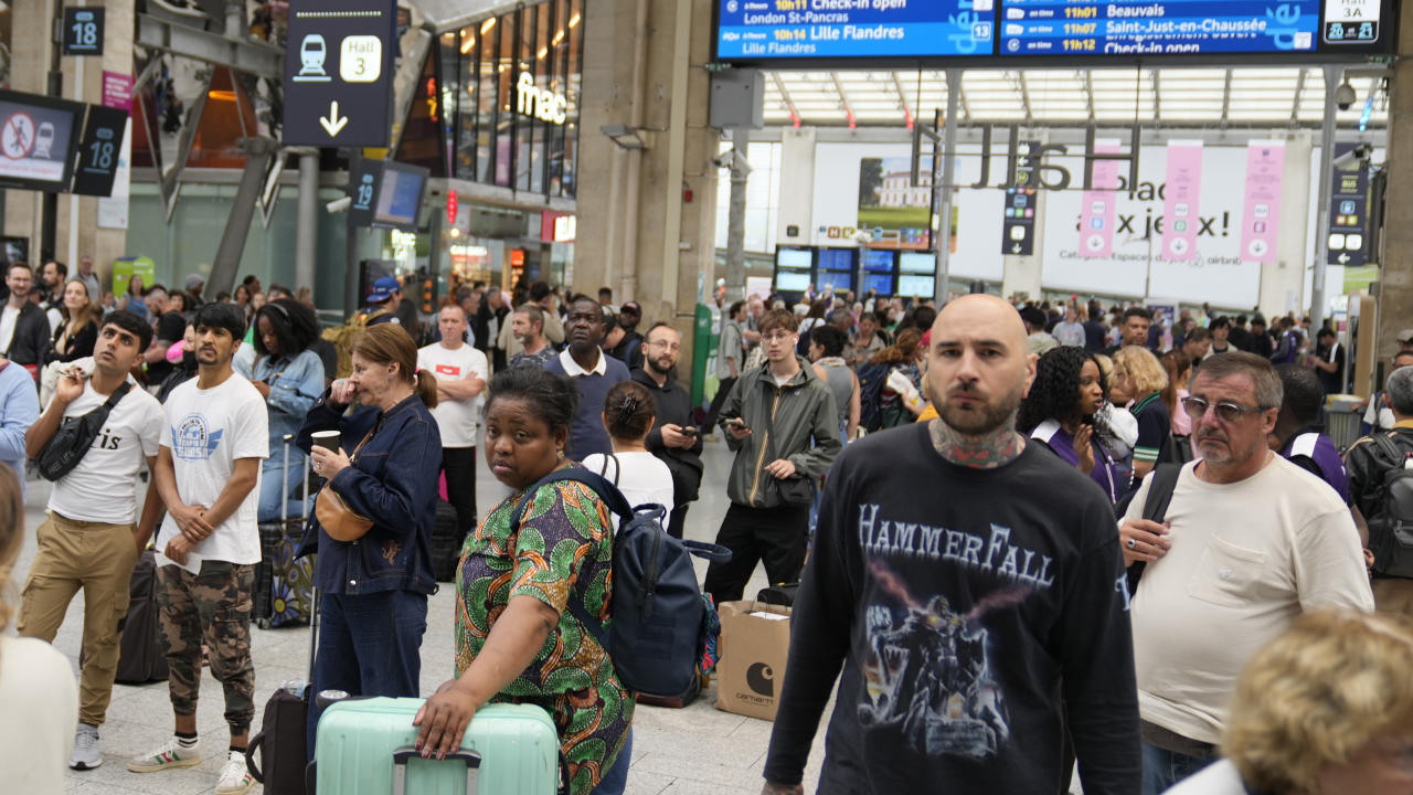 Travelers wait inside the Gare du Nord train station at the 2024 Summer Olympics, Friday, July 26, 2024, in Paris, France. Hours away from the grand opening ceremony of the Olympics, high-speed rail traffic to the French capital was severely disrupted on Friday by what officials described as 